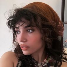 Plaid top and a brown head scarf.Plaid top and a brown head scarf.